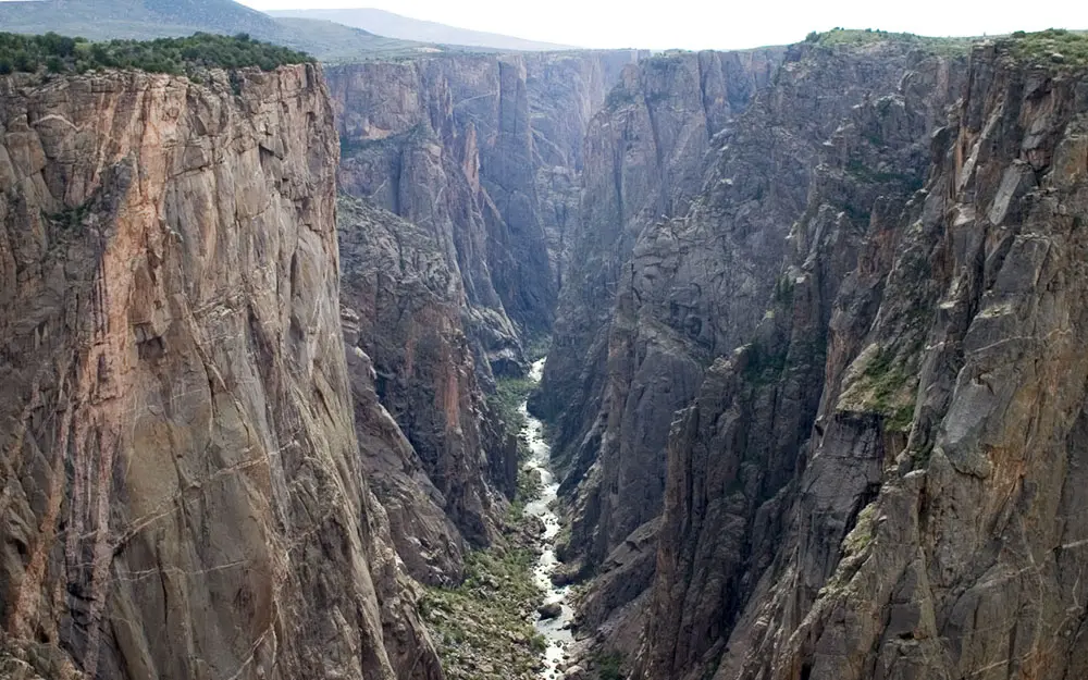 Large, rocky canyon with a river running through.